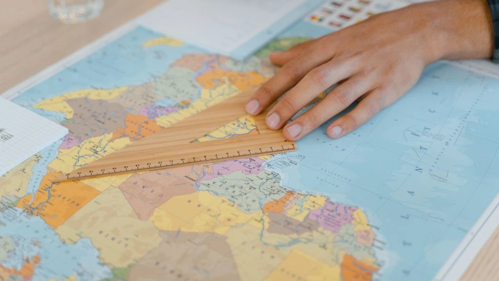 Dot-grid world map silhouette with signal arcs over major connectivity hubs